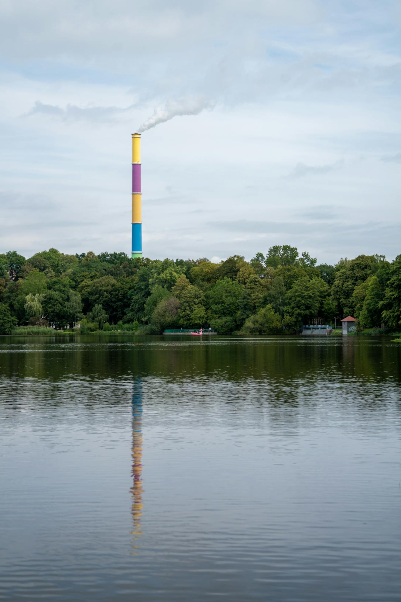 Industrial Chimney on Lake and Forest Landscape