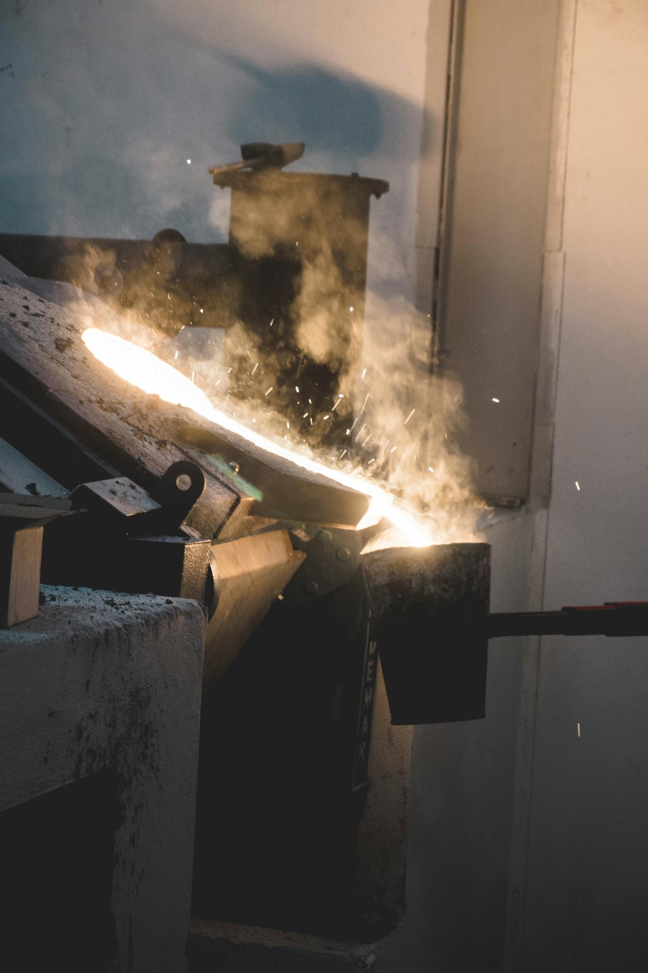 Melted Metal Pouring from the Furnace into a Container